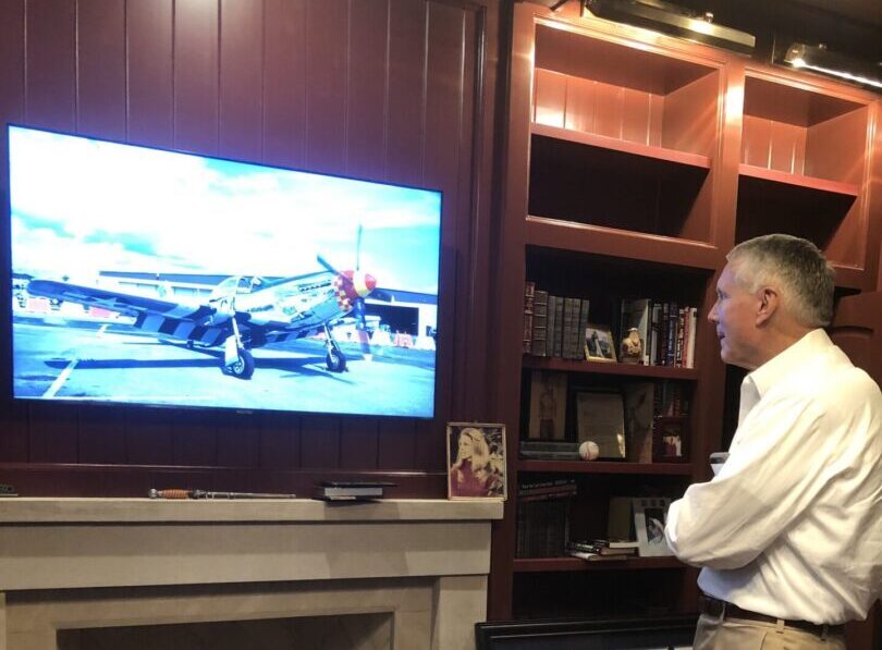 A man standing in front of a tv.