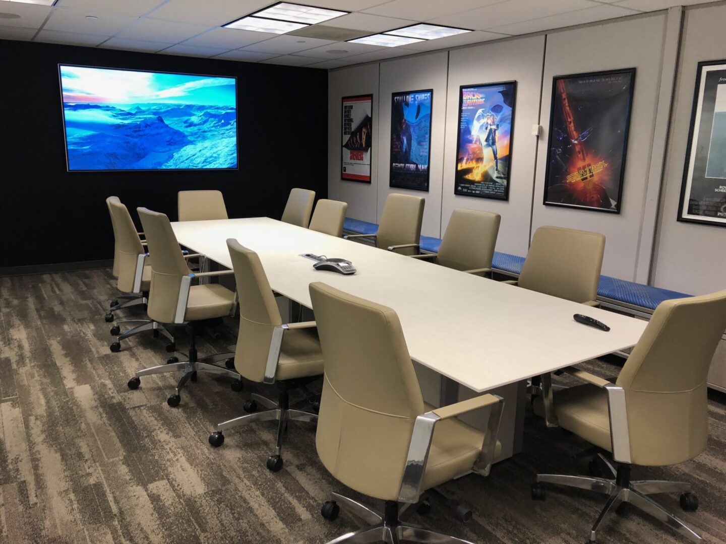 A conference room with a large table and chairs.